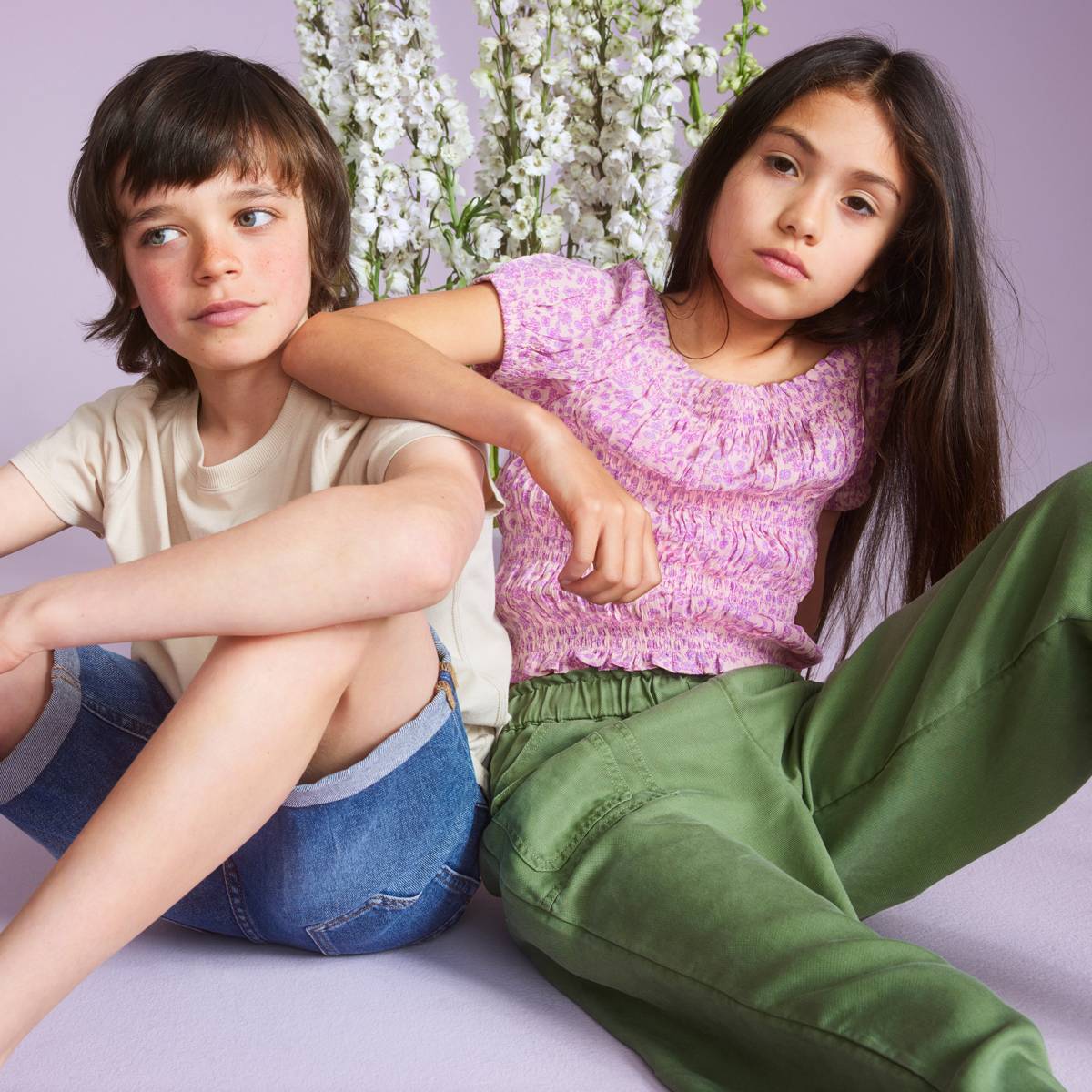Boy and girl wearing new everyday outfits. Shop new-in kidswear 